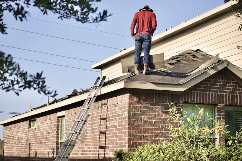 Professional roofer working on a residential roof in Cuyahoga Falls